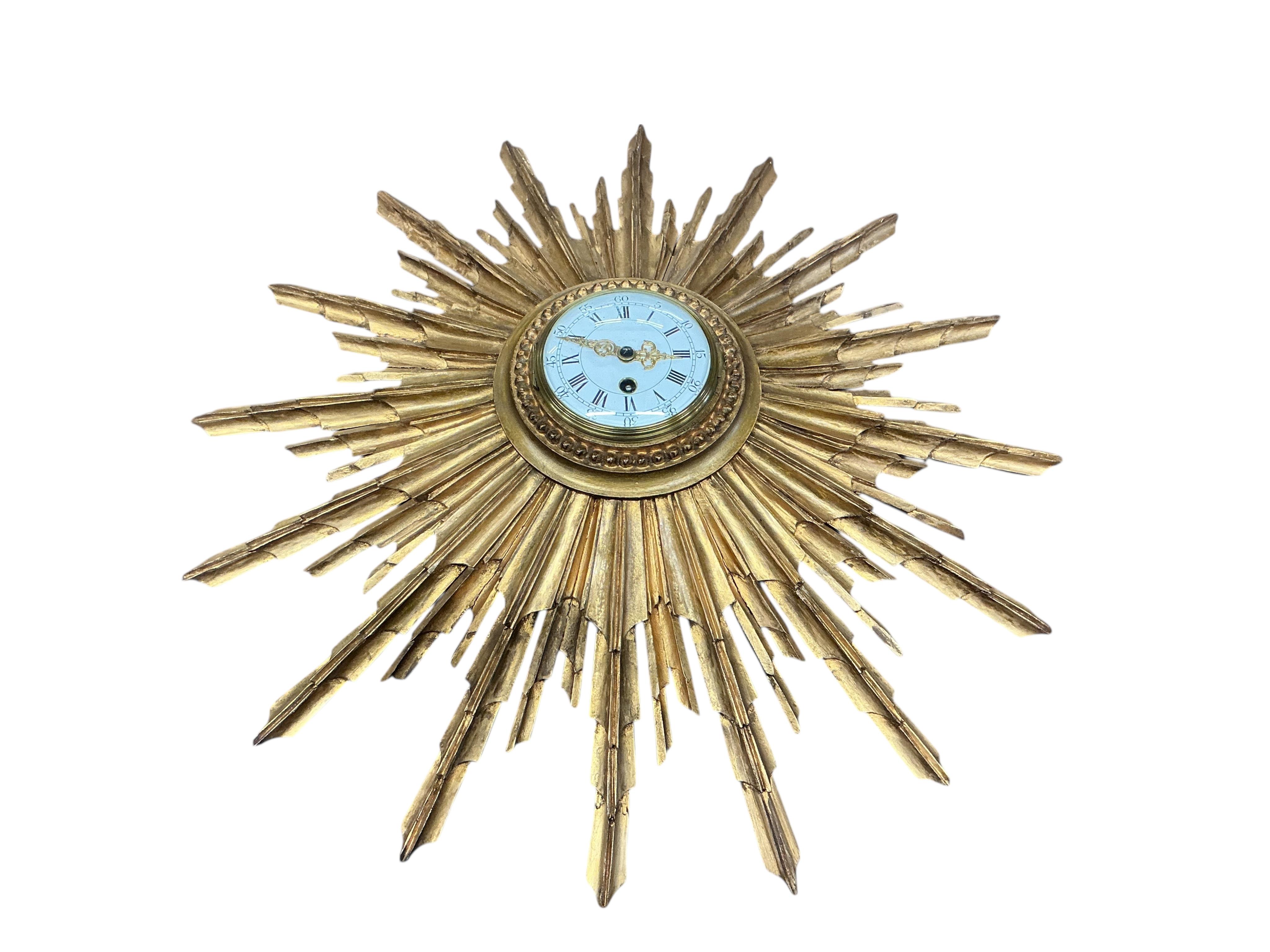 An early 20th century carved giltwood starburst wall timepiece, diameter 62cm